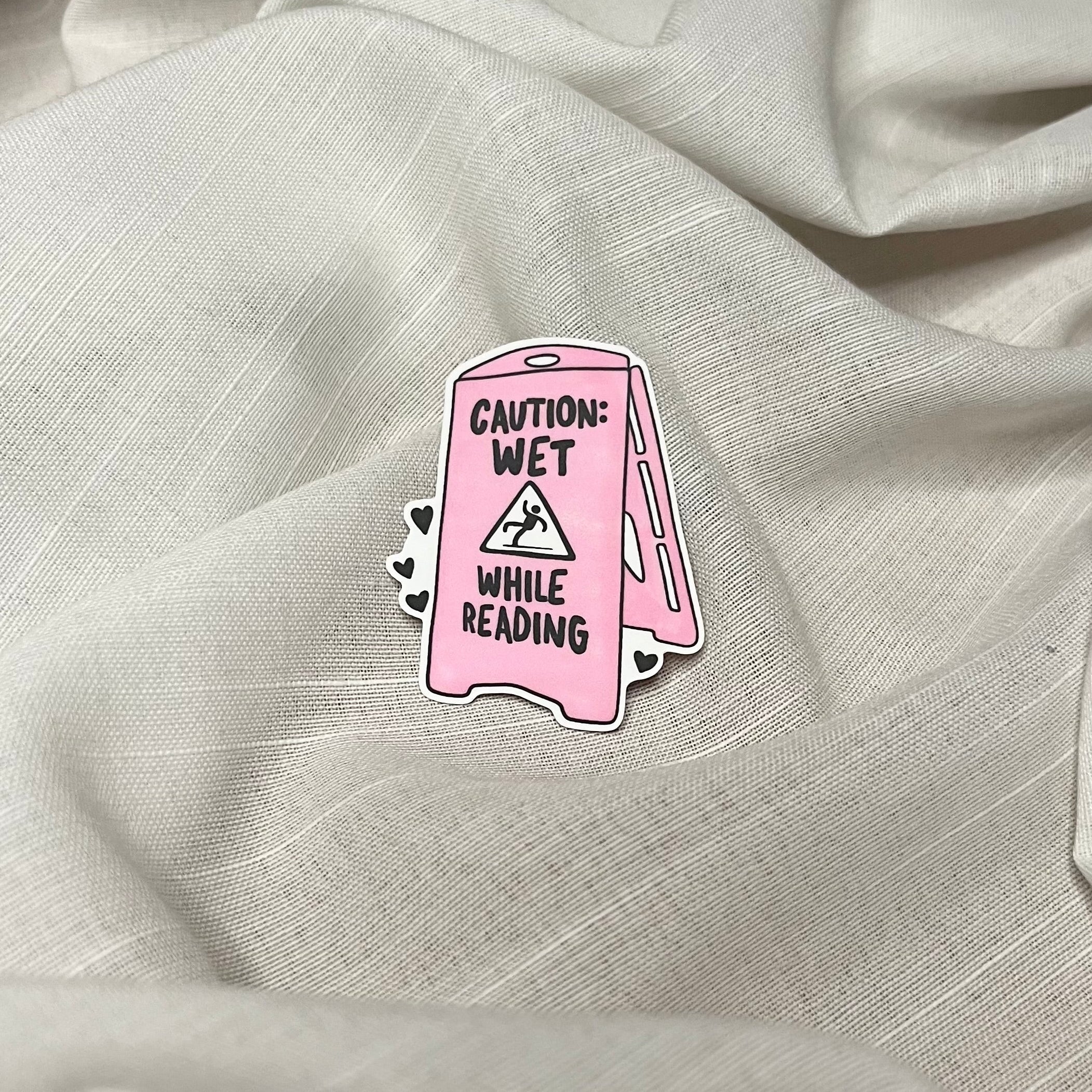 Caution: Wet While Reading Sticker